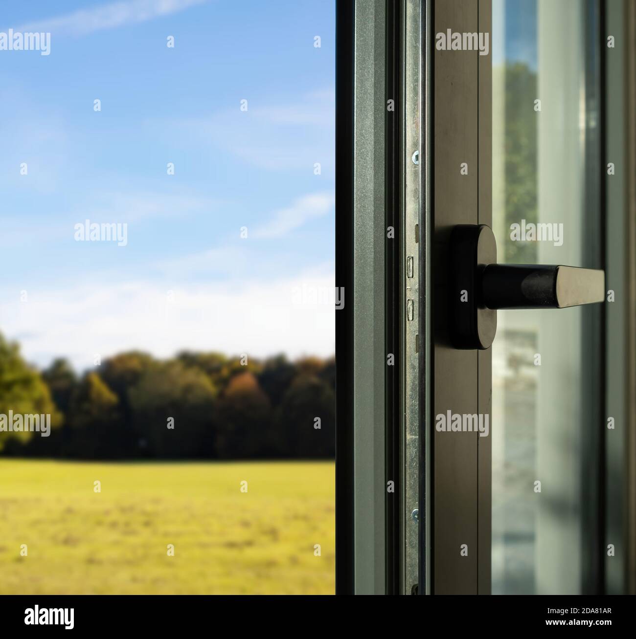 Aluminum door detail. Metal window frame open closeup view. Energy efficient, safety profile, blur outdoor nature background Stock Photo