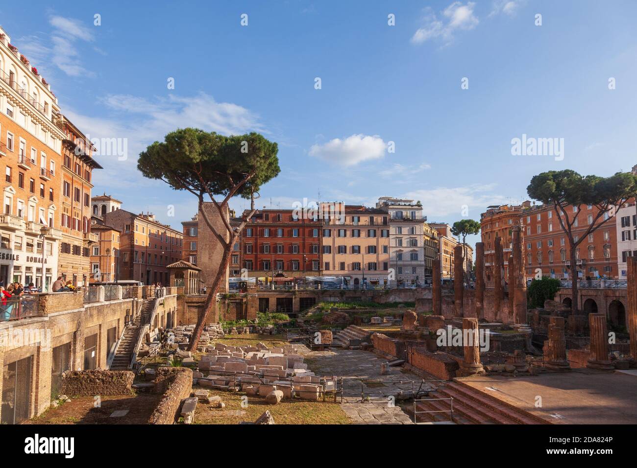 Rome, Italy - May 5, 2016: Tourists overlooking excavated ruins of Roman temples at Area sacra of Largo di Torre Argentina archaeological area Stock Photo