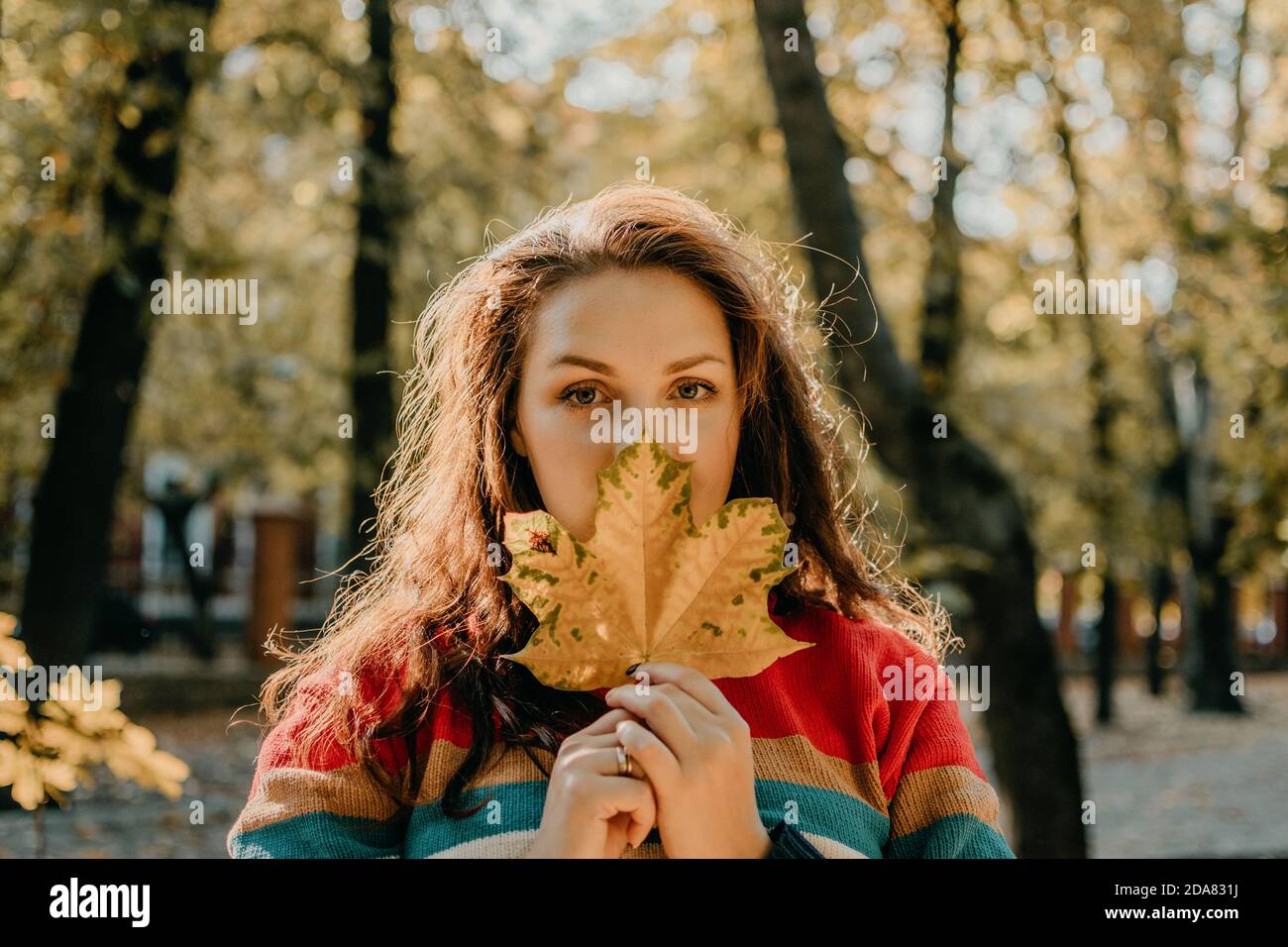 Body Shaming, Low self-worth concept. Sad plus size woman walking in autumn park. Stock Photo