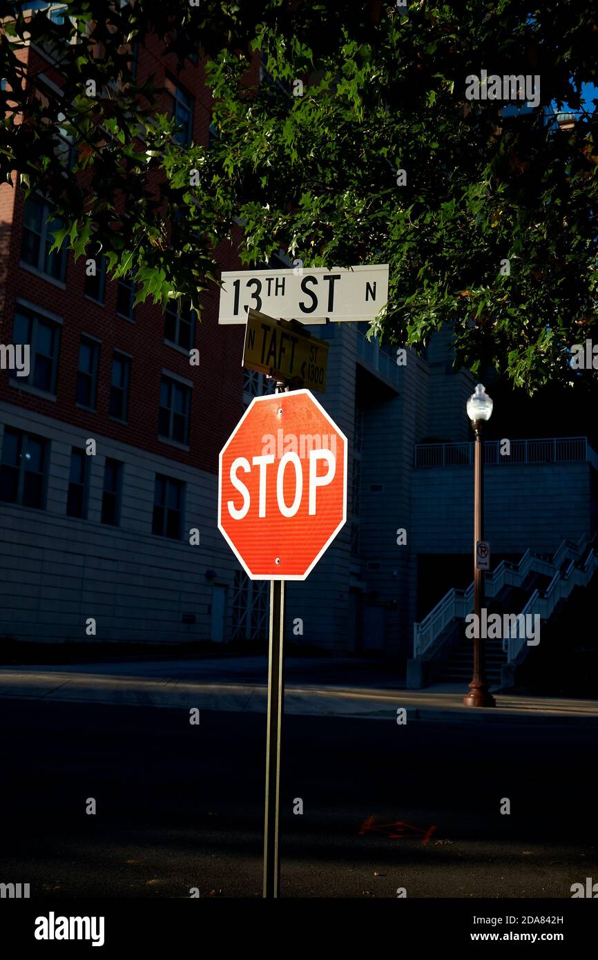 A bright, red, reflective Stop sign stands out against black at an
