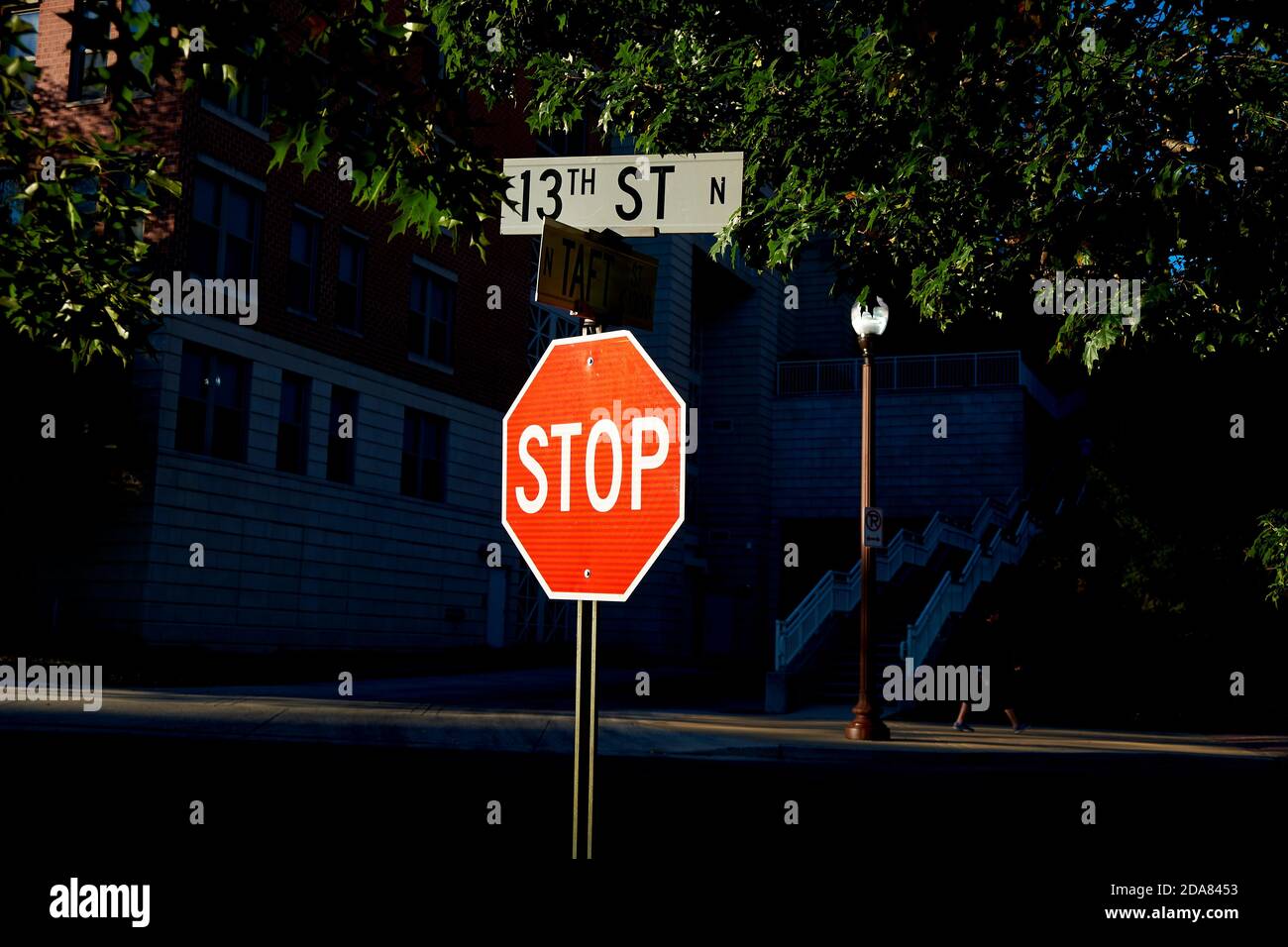 A bright, red, reflective Stop sign stands out against black at an