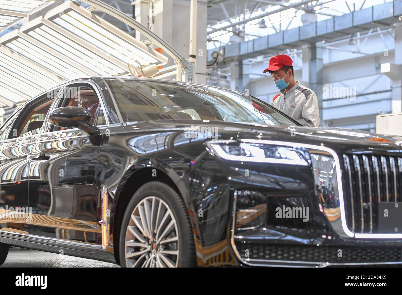 Changchun, China's Jilin Province. 23rd Sep, 2020. A worker checks a vehicle at the general assembly line of Hongqi, the leading sedan brand of First Automotive Works (FAW) Group Co. Ltd., in Changchun, northeast China's Jilin Province, Sept. 23, 2020. First Automotive Works (FAW) Group Co. Ltd., China's leading automaker, sold more than 3.01 million vehicles in the first 10 months of this year, an increase of 7.8 percent year on year, the company said. Credit: Zhang Nan/Xinhua/Alamy Live News Stock Photo