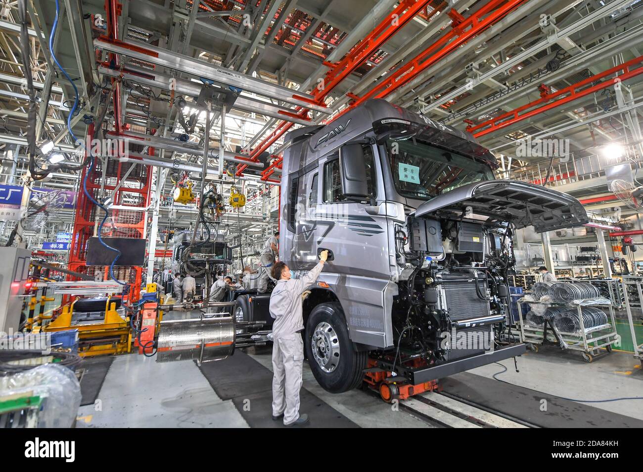 Changchun, China's Jilin Province. 23rd Sep, 2020. Workers assemble vehicles at the general assembly line of FAW Jiefang, a truck-manufacturing subsidiary of First Automotive Works (FAW) Group Co. Ltd., in Changchun, northeast China's Jilin Province, Sept. 23, 2020. First Automotive Works (FAW) Group Co. Ltd., China's leading automaker, sold more than 3.01 million vehicles in the first 10 months of this year, an increase of 7.8 percent year on year, the company said. Credit: Zhang Nan/Xinhua/Alamy Live News Stock Photo