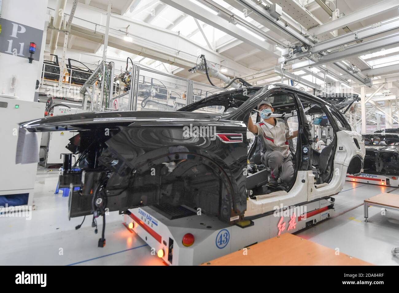 Changchun, China's Jilin Province. 23rd Sep, 2020. A worker assembles a vehicle at the general assembly line of Hongqi, the leading sedan brand of First Automotive Works (FAW) Group Co. Ltd., in Changchun, northeast China's Jilin Province, Sept. 23, 2020. First Automotive Works (FAW) Group Co. Ltd., China's leading automaker, sold more than 3.01 million vehicles in the first 10 months of this year, an increase of 7.8 percent year on year, the company said. Credit: Zhang Nan/Xinhua/Alamy Live News Stock Photo