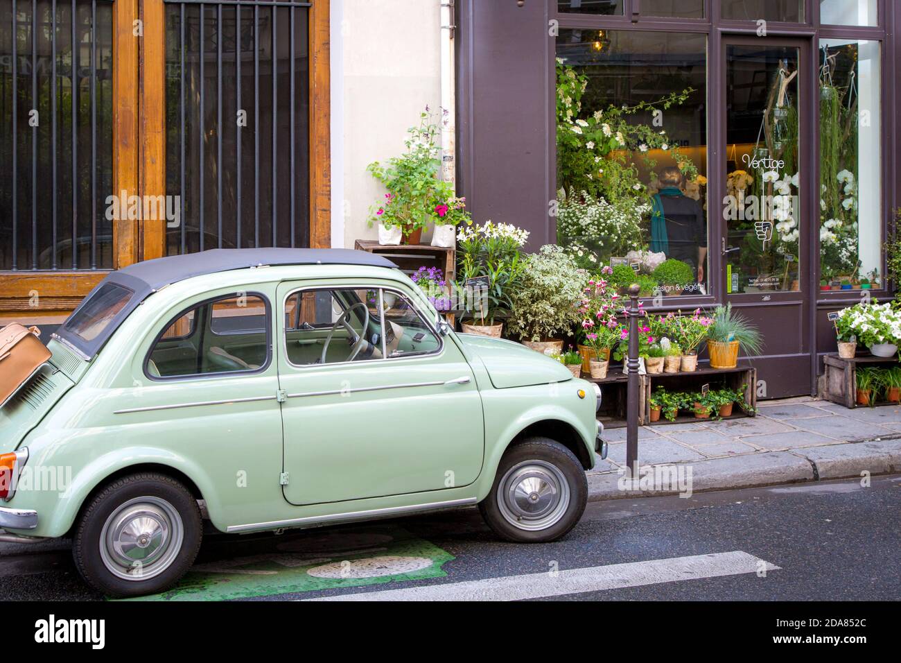Fiat parked on the sidewalk at the florist shop, Les Marais, Paris, France Stock Photo