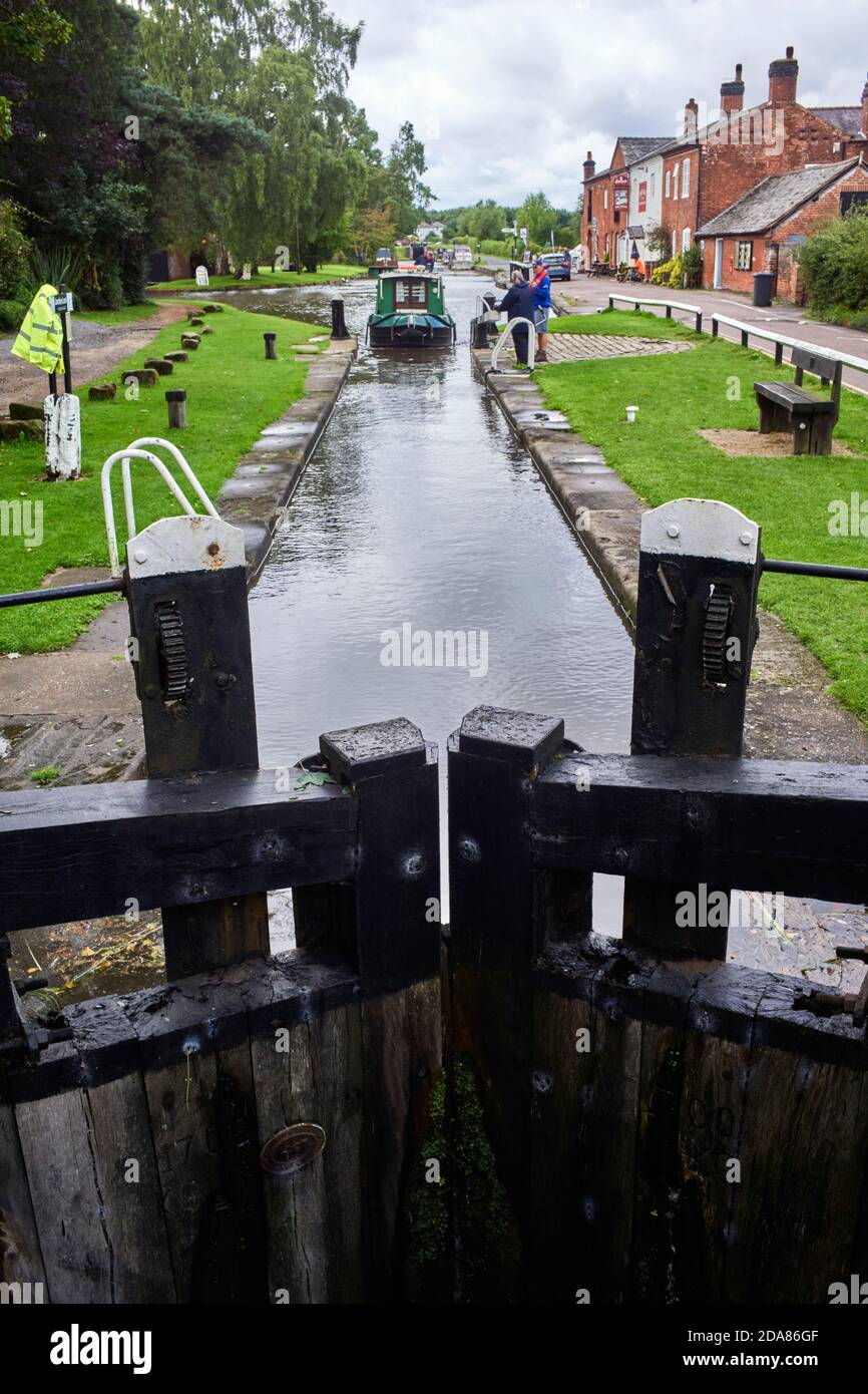 Narrowboat coming into the lock at Fradley Junction on the Trent and Mersey Canal Stock Photo