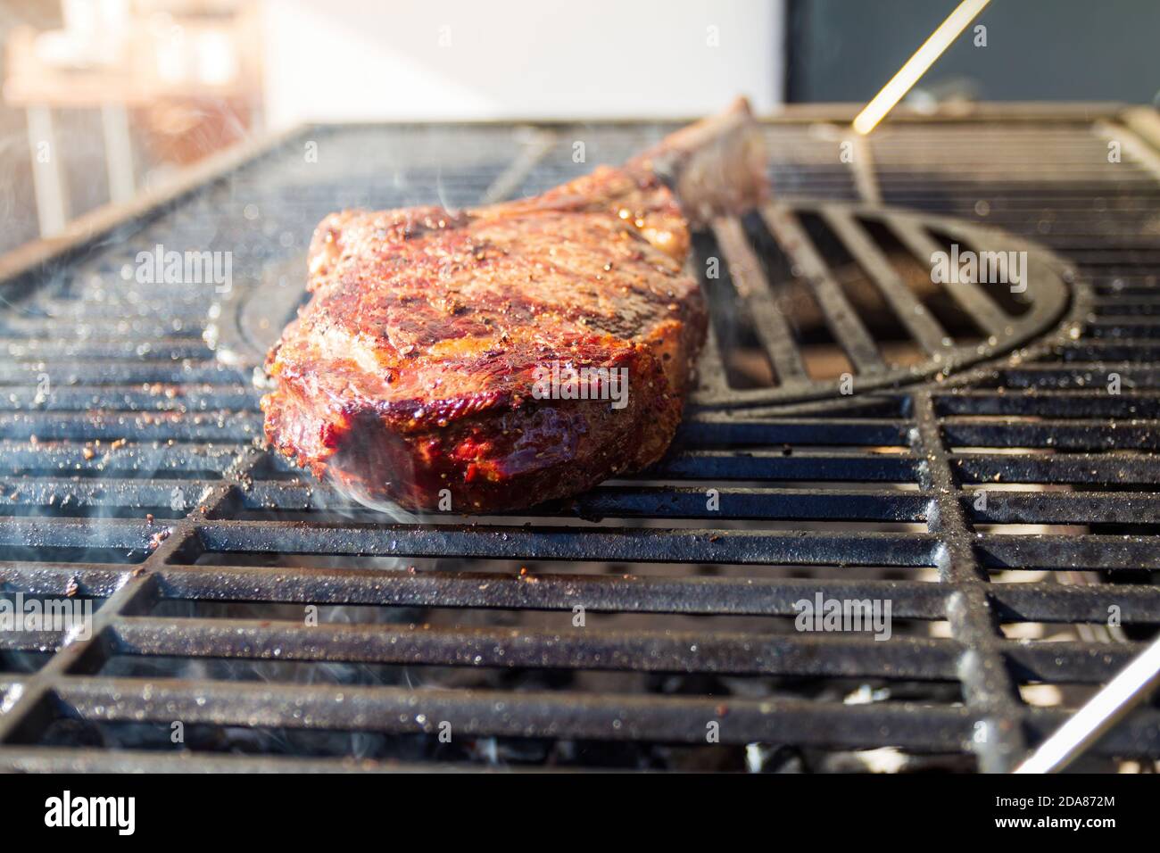 Dry Aged Barbecue Tomahawk Steak on grill Stock Photo