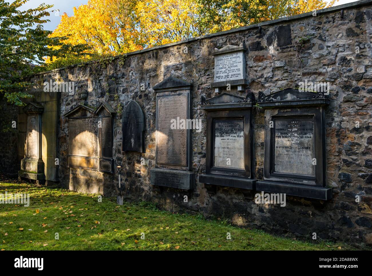 Graves in wall in South Leith parish church graveyard in Autumn,  Edinburgh Scotland, UK Stock Photo