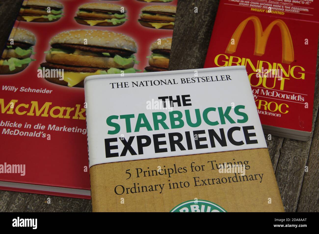 Viersen, Germany - May 1. 2020: Closeup of books about trademarks Mcdonalds and Starbucks franchise business Stock Photo