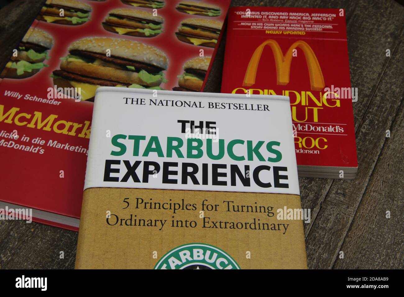 Viersen, Germany - May 1. 2020: Closeup of books about trademarks Mcdonalds and Starbucks franchise business Stock Photo