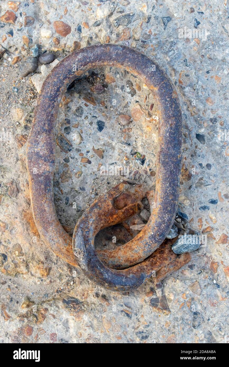 Closeup showing the texture of a old rusty chain forming the letter Q Stock Photo
