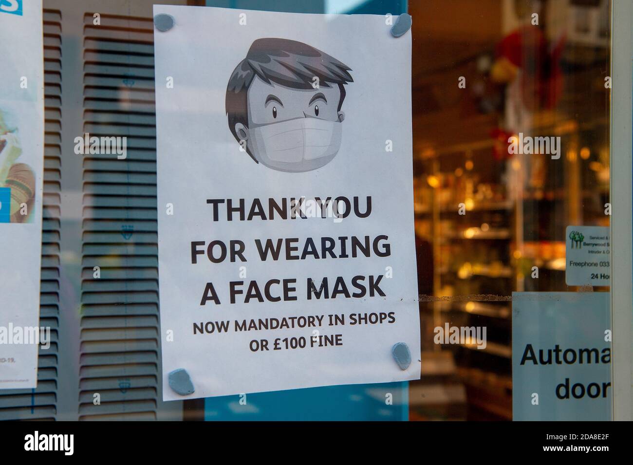 Sunninghill, Berkshire, UK. 10th November, 2020. A Covid-19 face mask sign in a corner shop in Sunninghill reminding customers that they may be fined £100 if they fail to wear a facemask. Credit: Maureen McLean/Alamy Stock Photo