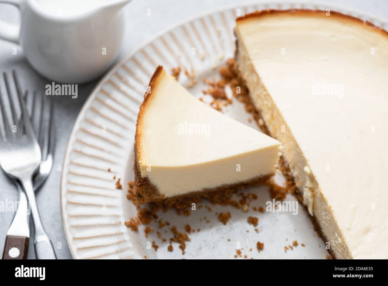 Classical new york cheesecake with slice cut out on a plate. Tasty cheesecake Stock Photo