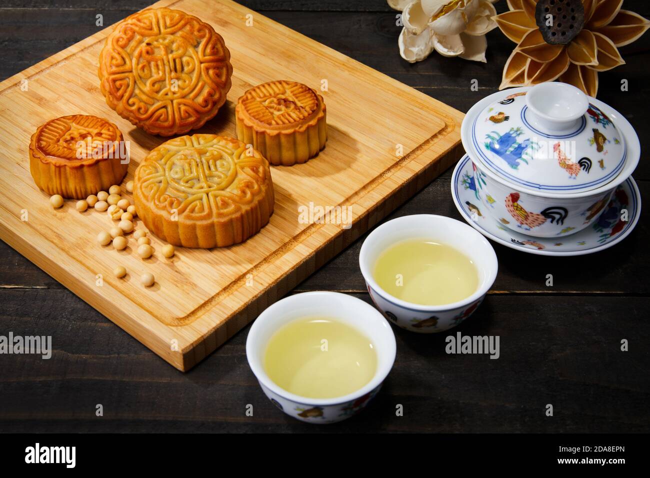 High angle shot of cookies and cups of herbal tea on a wooden surface ...