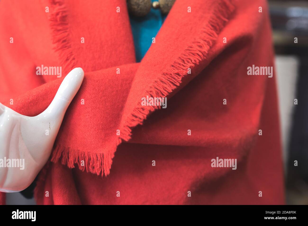 Red cashmere wool scarf, classic fashion, a hand of a white mannequin with red stole Stock Photo