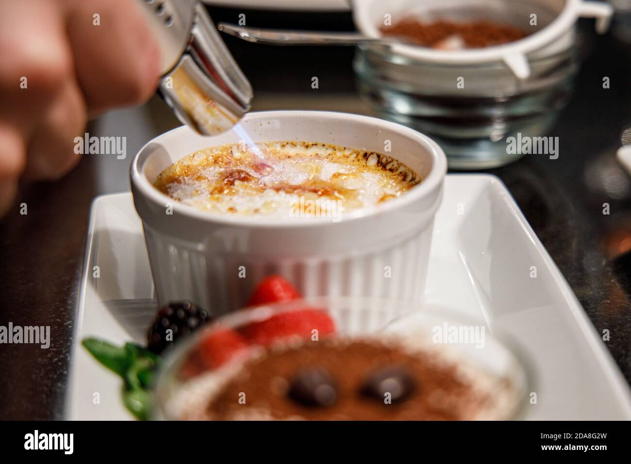 Making creme brulee with a gas torch, picture shows caramelizing of