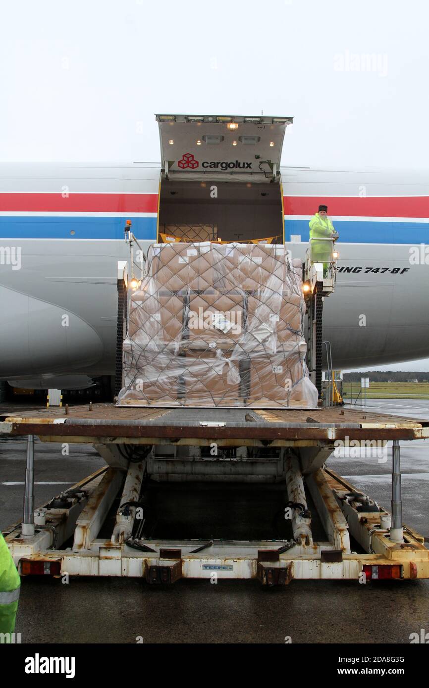 Glasgow Prestwick Airport, Ayrshire, Scotland, UK. Boeing 747/8f Cargolux maiden flight City of Luxemburg lands at Glasgow Prestwick Airport with GE Caledonian Apprentices and managers watching and inspecting the aircraft and it operation on the apron. Unloading from the side of the aircraft Stock Photo