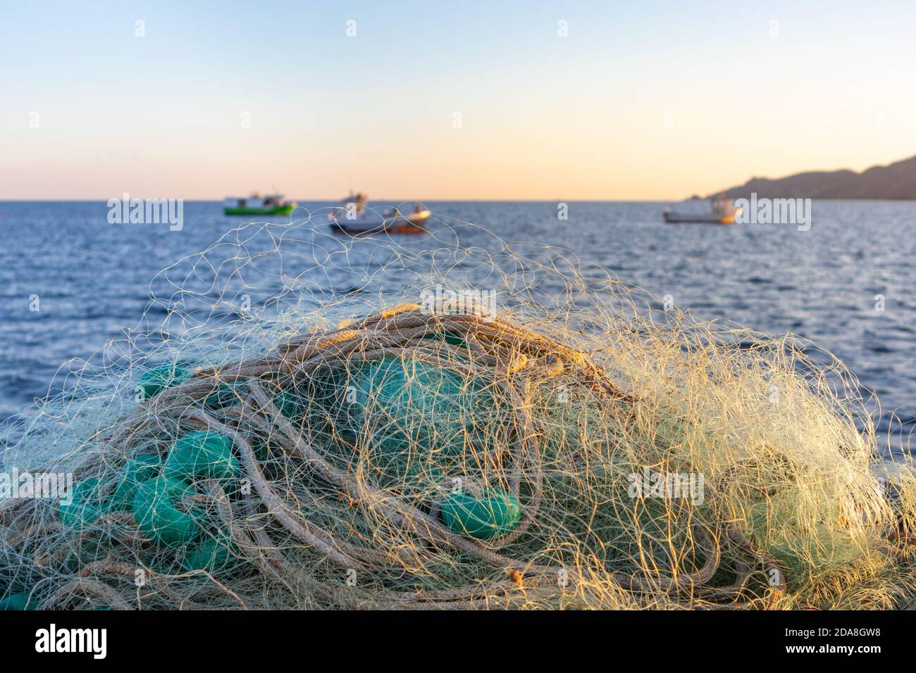 Traditional fishing net and small fishing boats behind. Traditional