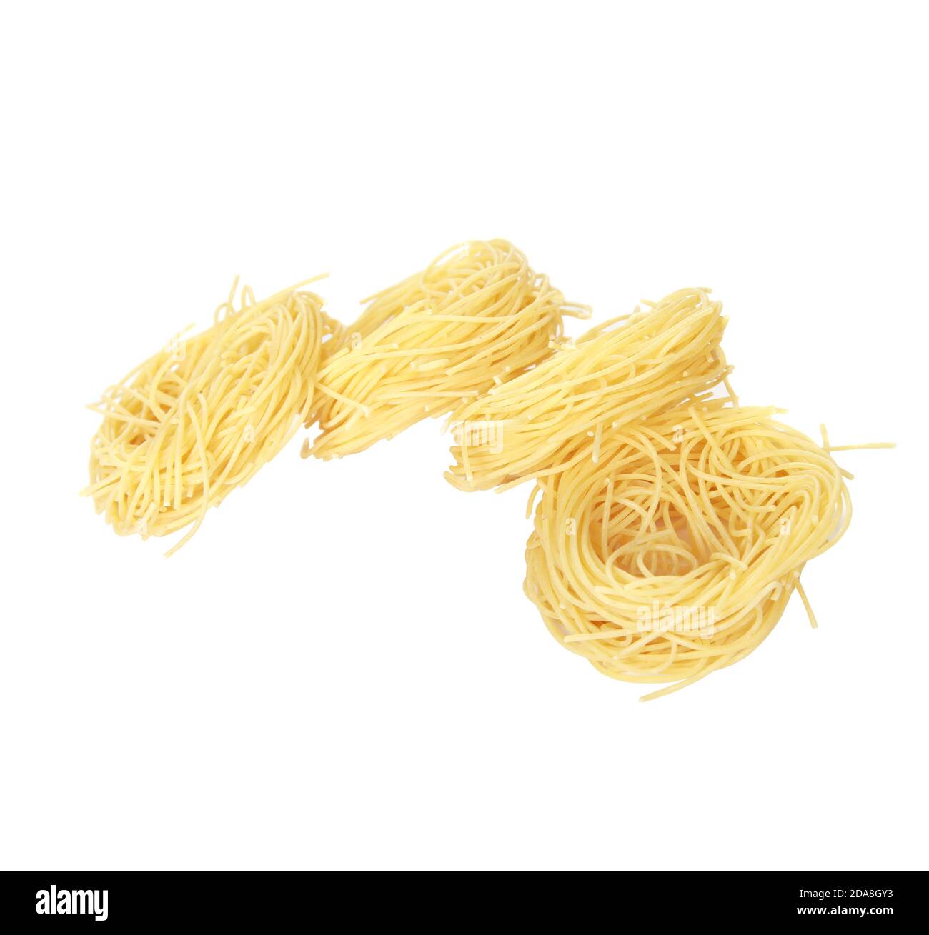 Rolls of dry spaghetti noodles isolated on a white background Stock