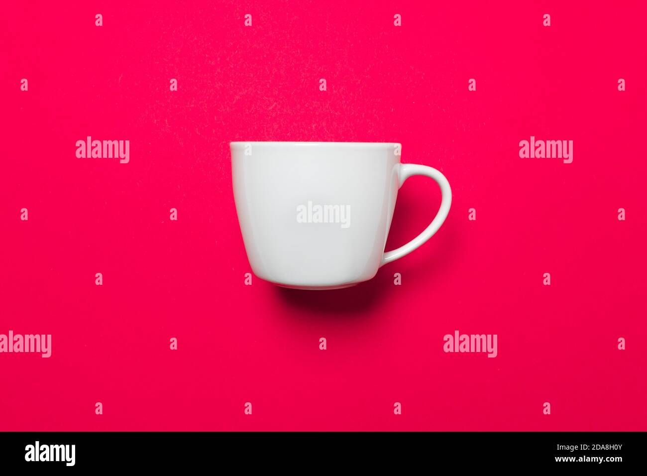 One white coffee mug on a pink uniform background with soft light and shadows, use as virtual background for zoom meetings Stock Photo