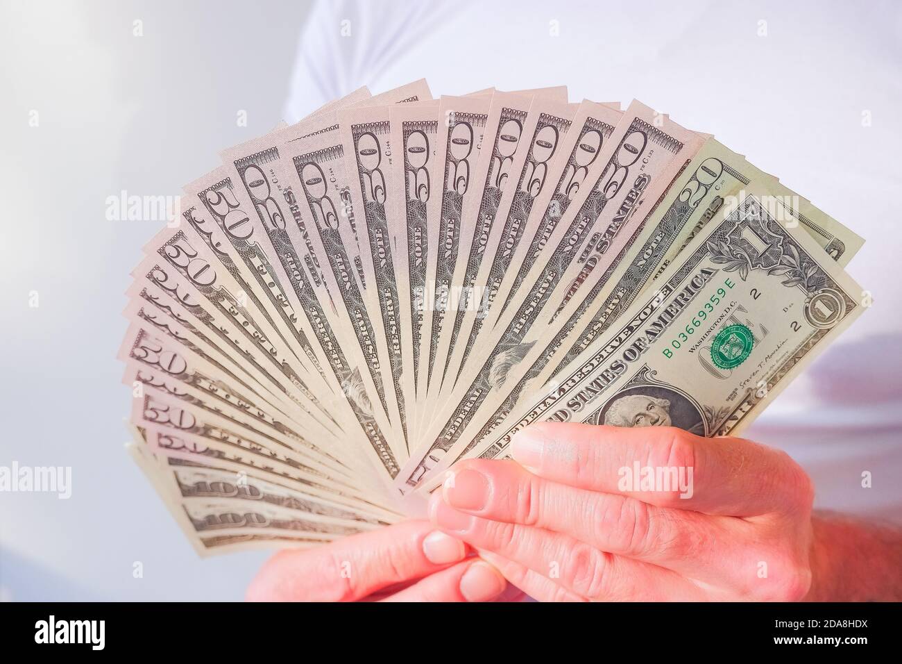 Hand holds american Dollarbills.Adult man hands count money Stock