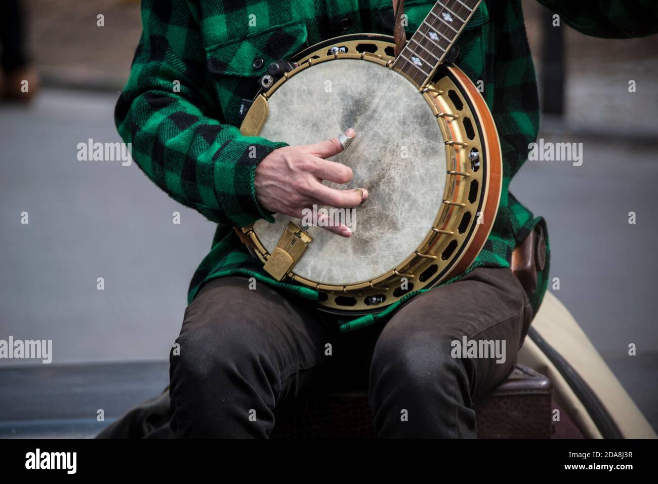 Close-up of hand of musician of the duo Coyote & Crow playing bluegrass on 5-string banjo in Washington Square Park, Greenwich Village, NYC. NY Stock Photo