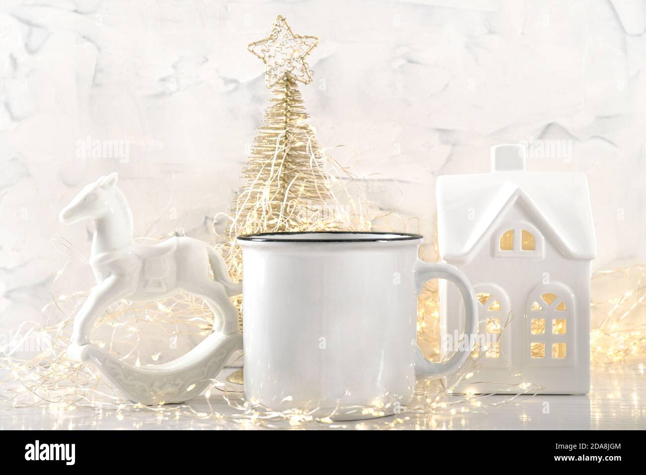 White mug with Christmas lights decoration background Stock Photo