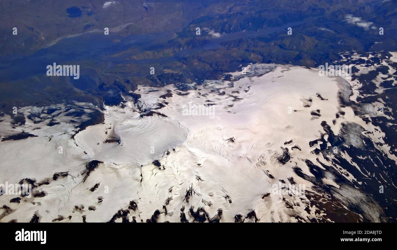 A volcanic crater is clearly defined by snow in this photo taken over Iceland in the middle of summer Stock Photo