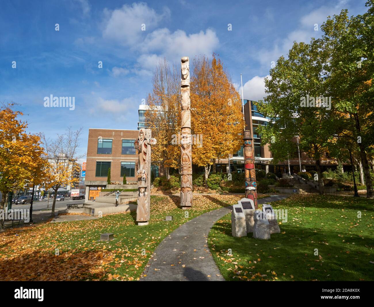 Kwakiutl style Reconciliation totem pole and Coast Salish Welcome Posts outside the Vancouver School Board building, Vancouver, BC, Canada Stock Photo