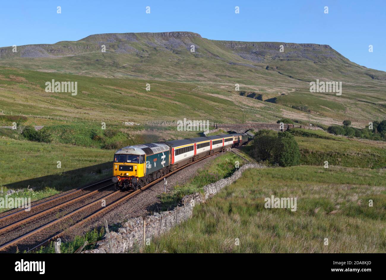 'The Staycation Express' train passing Ais Gill summit on the scenic Settle to Carlisle railway line hauled by  class 47 locomotive 47593 Stock Photo