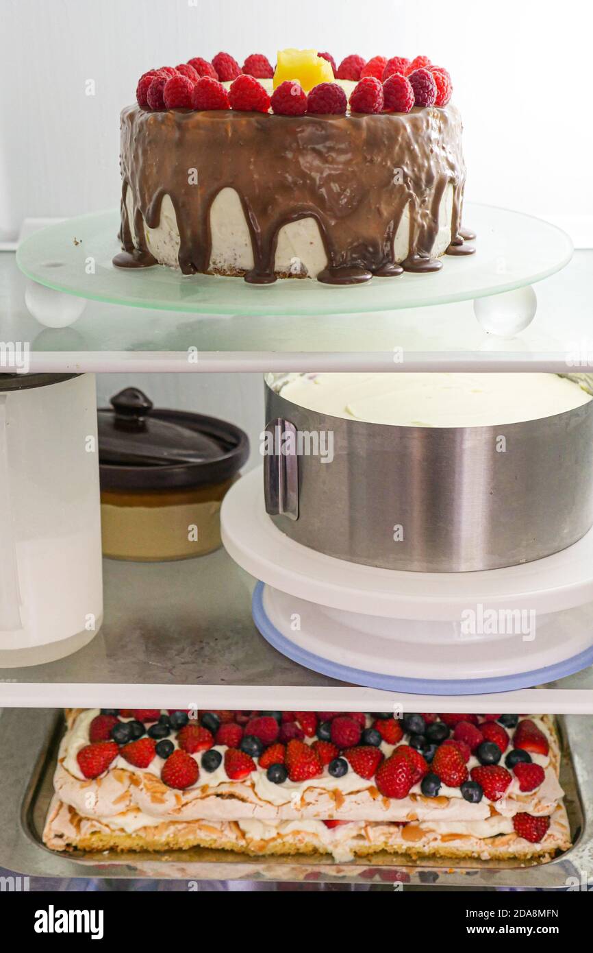 Refrigerator shelves with whole prepared homemade cakes. Stock Photo
