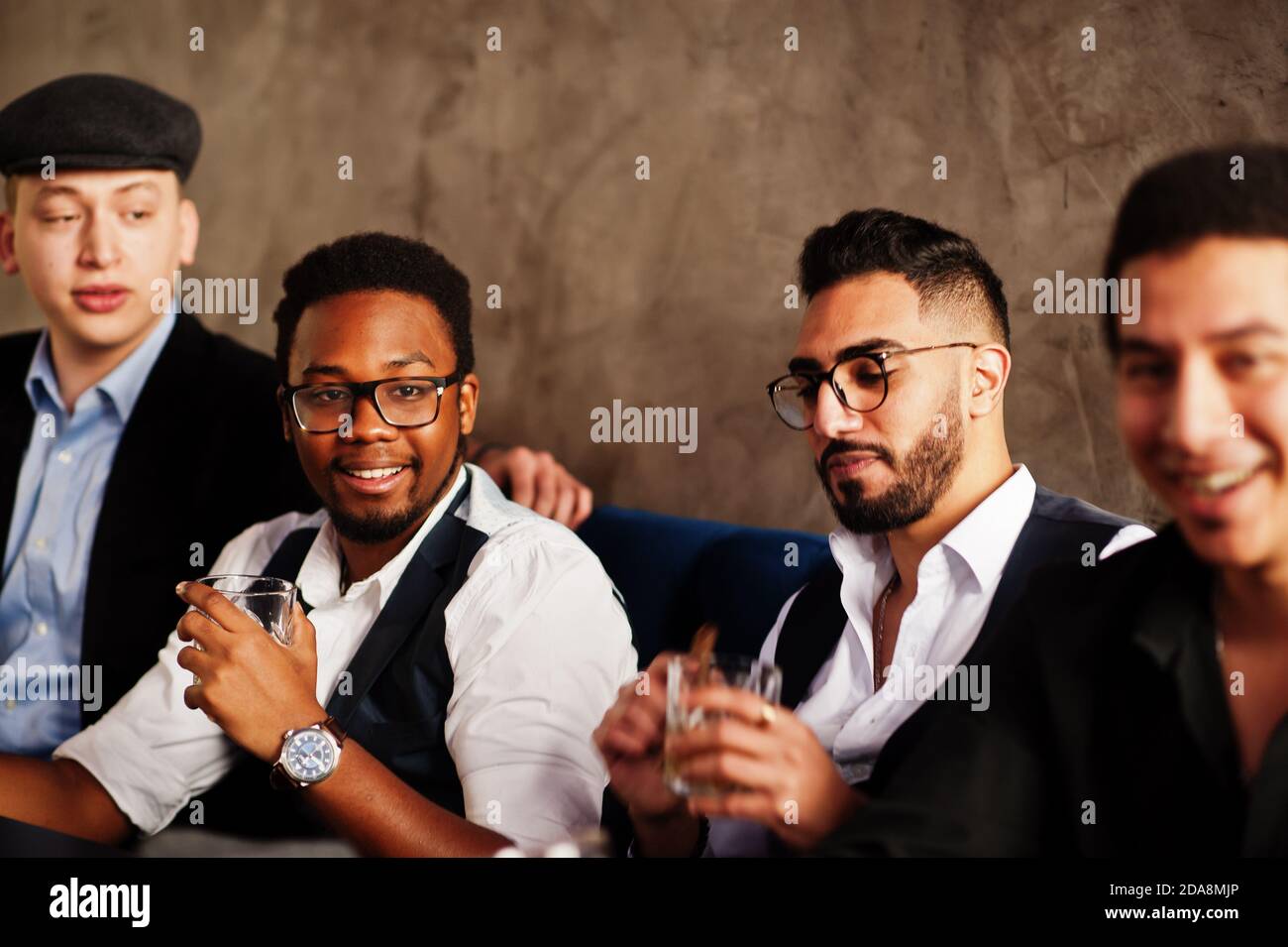 Group of handsome retro well-dressed man gangsters spend time at club,  sitting and drinking whiskey. Multiethnic male bachelor mafia party in  restaura Stock Photo - Alamy