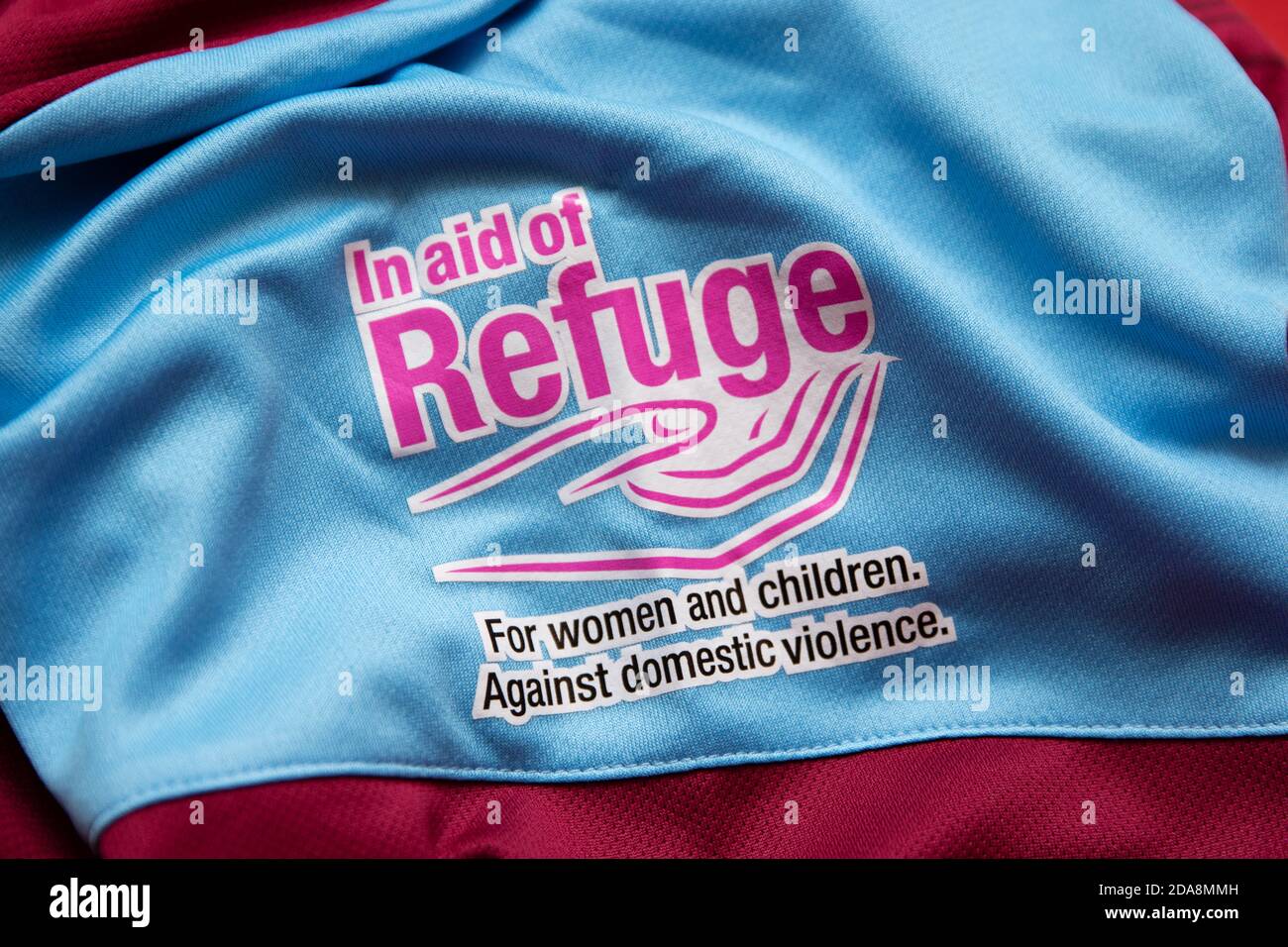 In Aid Of Refuge badge on the sleeve of the Weymouth FC Women's Home Shirt. Stock Photo