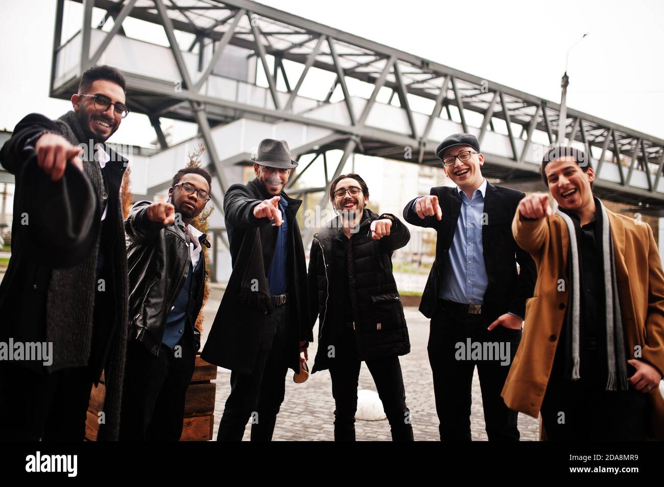 Group of handsome retro welldressed man gangsters smoking outdoor