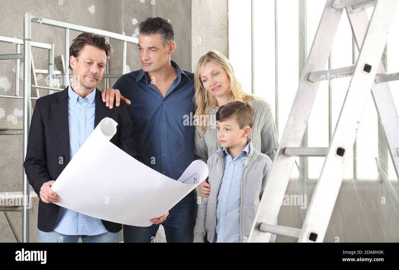 Architect showing house design plans to a family with child. Meeting at ...