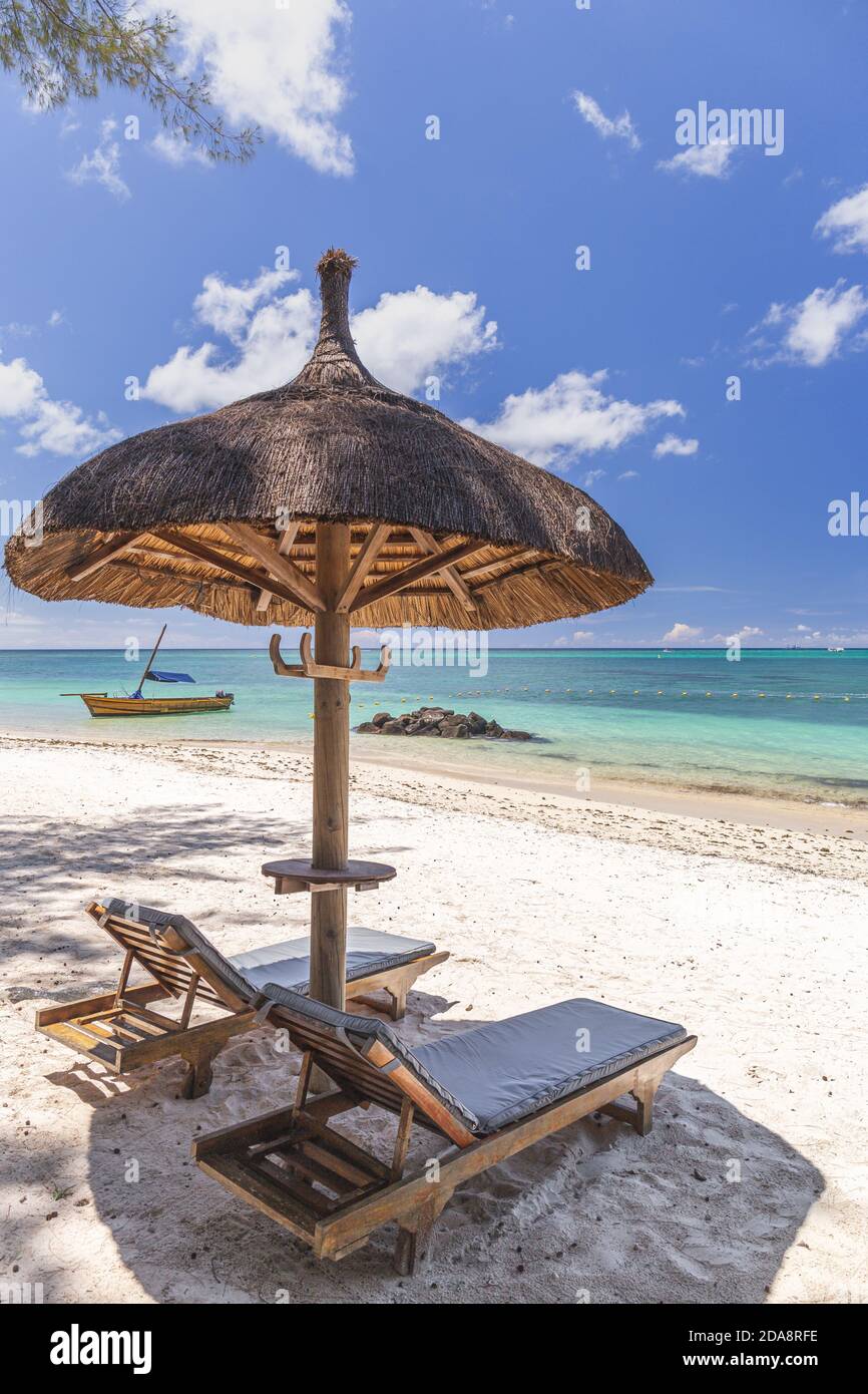 Beautiful beach of Mauritius island,view with torquise sea ,palm trees and umbrella. Stock Photo