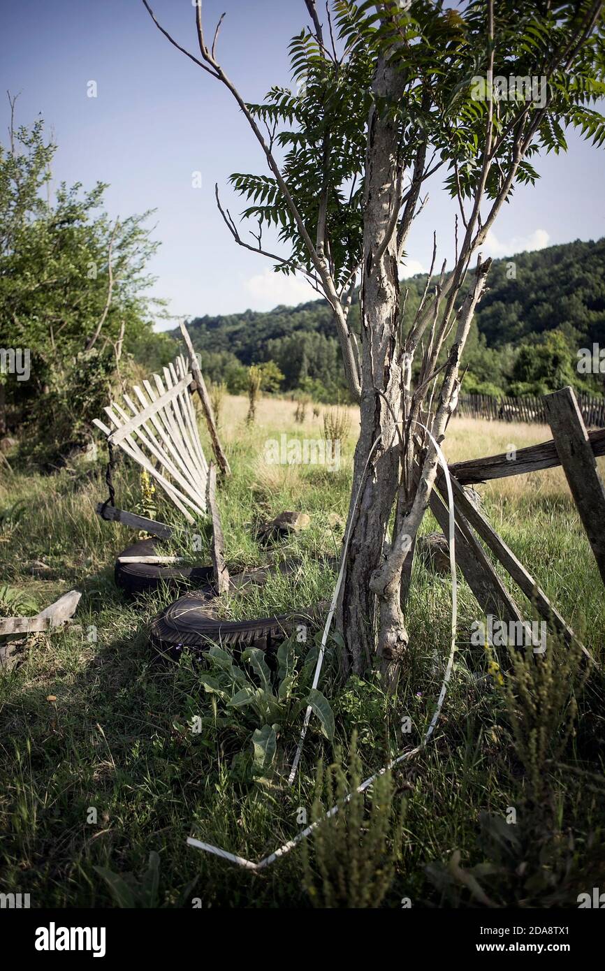 Broken wooden fence with some old tires in the village of Donja Kamenica near Stara Mountain in Knjazevac municipality, East Serbia. Stock Photo