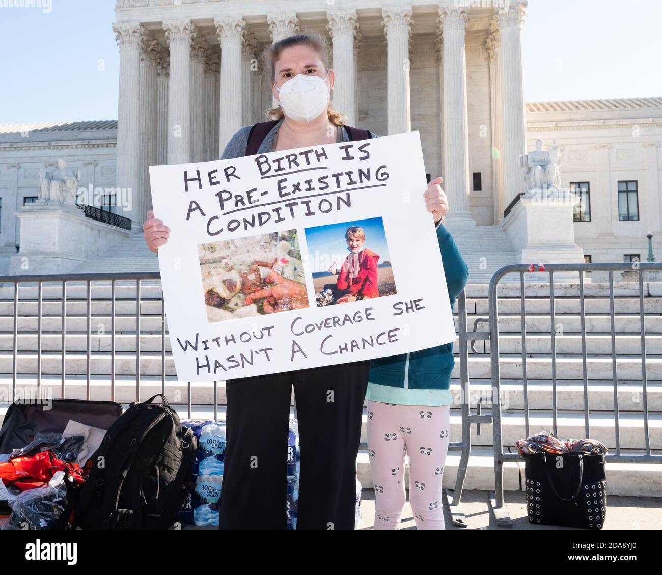Washington, U.S. 10th Nov, 2020. November 10, 2020 - Washington, DC, United States: Woman with a sign saying 'Her birth is a pre-existing condition, without coverage she hasn't a chance' at a demonstration in front of the Supreme Court in favor of the Affordable Care Act (ACA) on the day that the Supreme Court is hearing arguments in a case regarding it. (Photo by Michael Brochstein/Sipa USA) Credit: Sipa USA/Alamy Live News Stock Photo