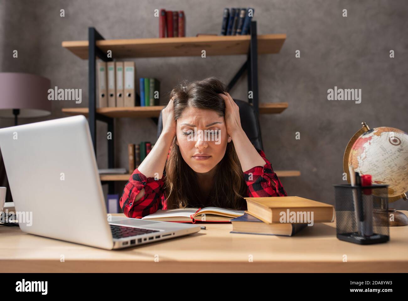 Confused woman teleworker works at home . She is in smart working due to covid-19 pandemic Stock Photo