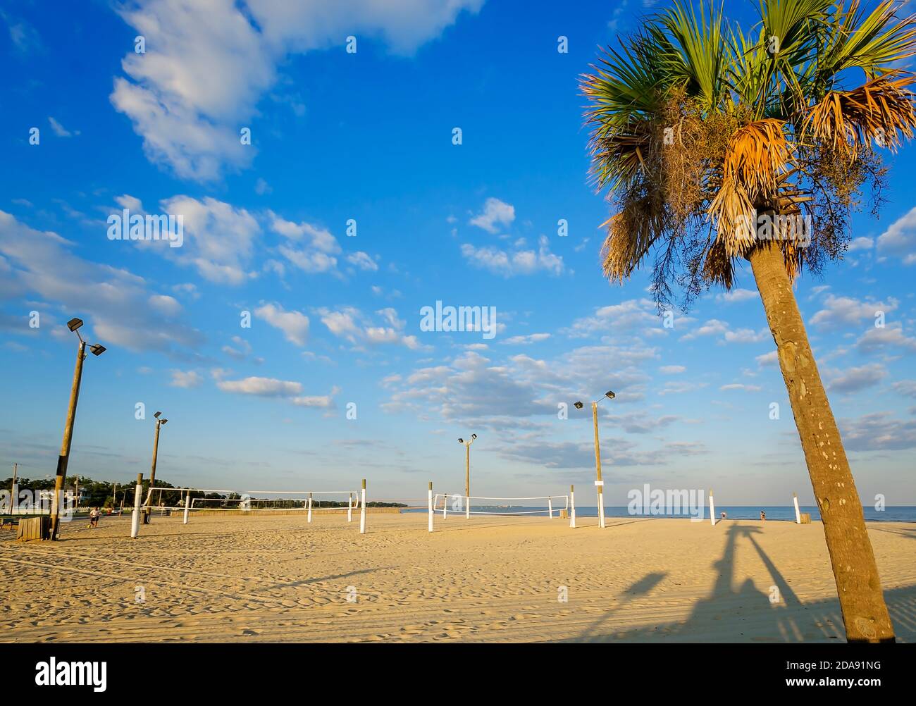 The sand beach features volleyball nets alongside Garfield Ladner Memorial Pier, Aug. 27, 2015, in Waveland, Mississippi. Stock Photo