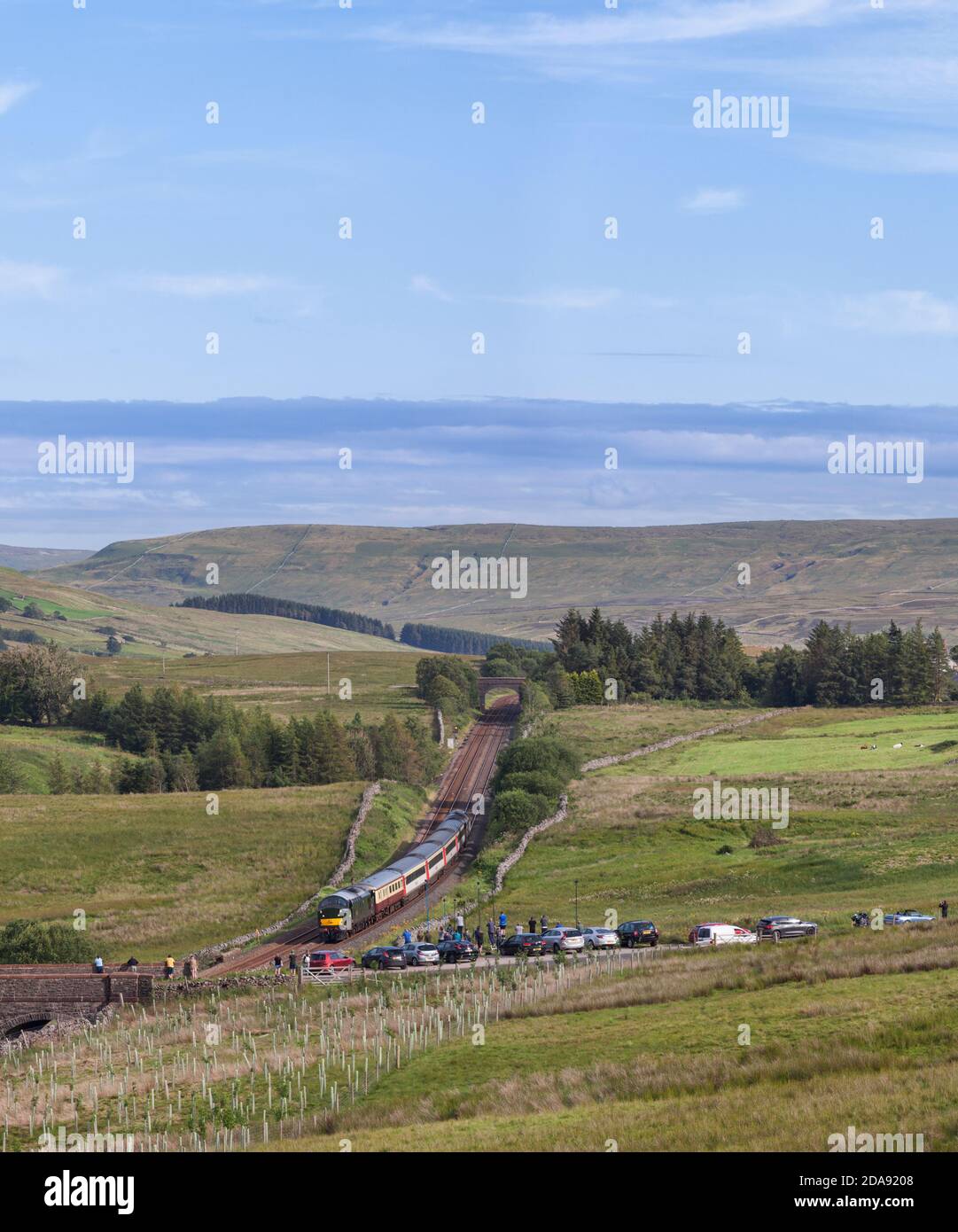 'The Staycation Express' tourist train passing Ais Gill summit on the scenic Settle to Carlisle railway line hauled by  class 37 locomotive 37521 Stock Photo