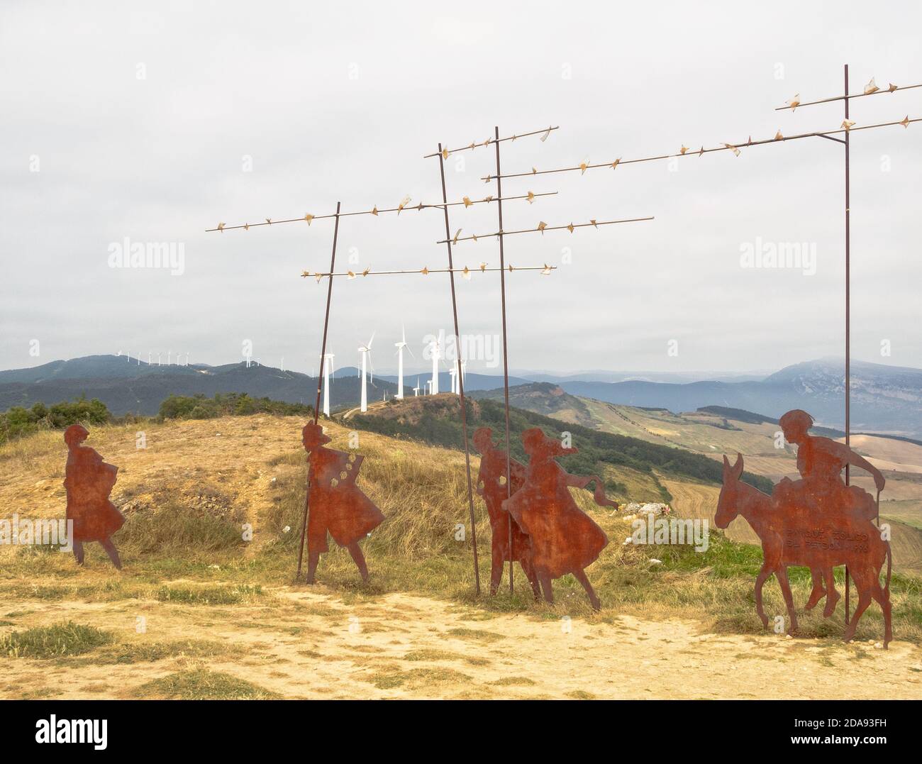 Life-size wrought iron pilgrims' monument of Vicente Galbete erected by the Friends of the Way of Navarre in 1996 on the Mount of Forgiveness - Alto d Stock Photo