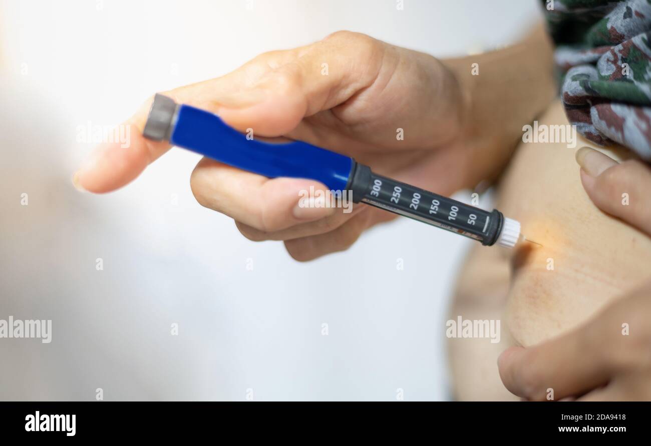 The diabetic patient hand using the insulin pen injection medical