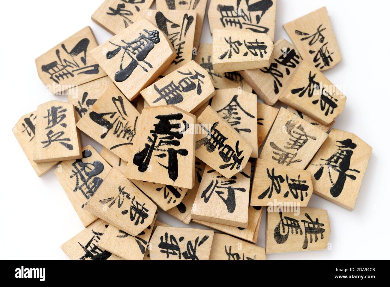 Japanese Shogi pieces and Sensu on a white background, Shogi is Japanese chess. Word that is w Stock Photo