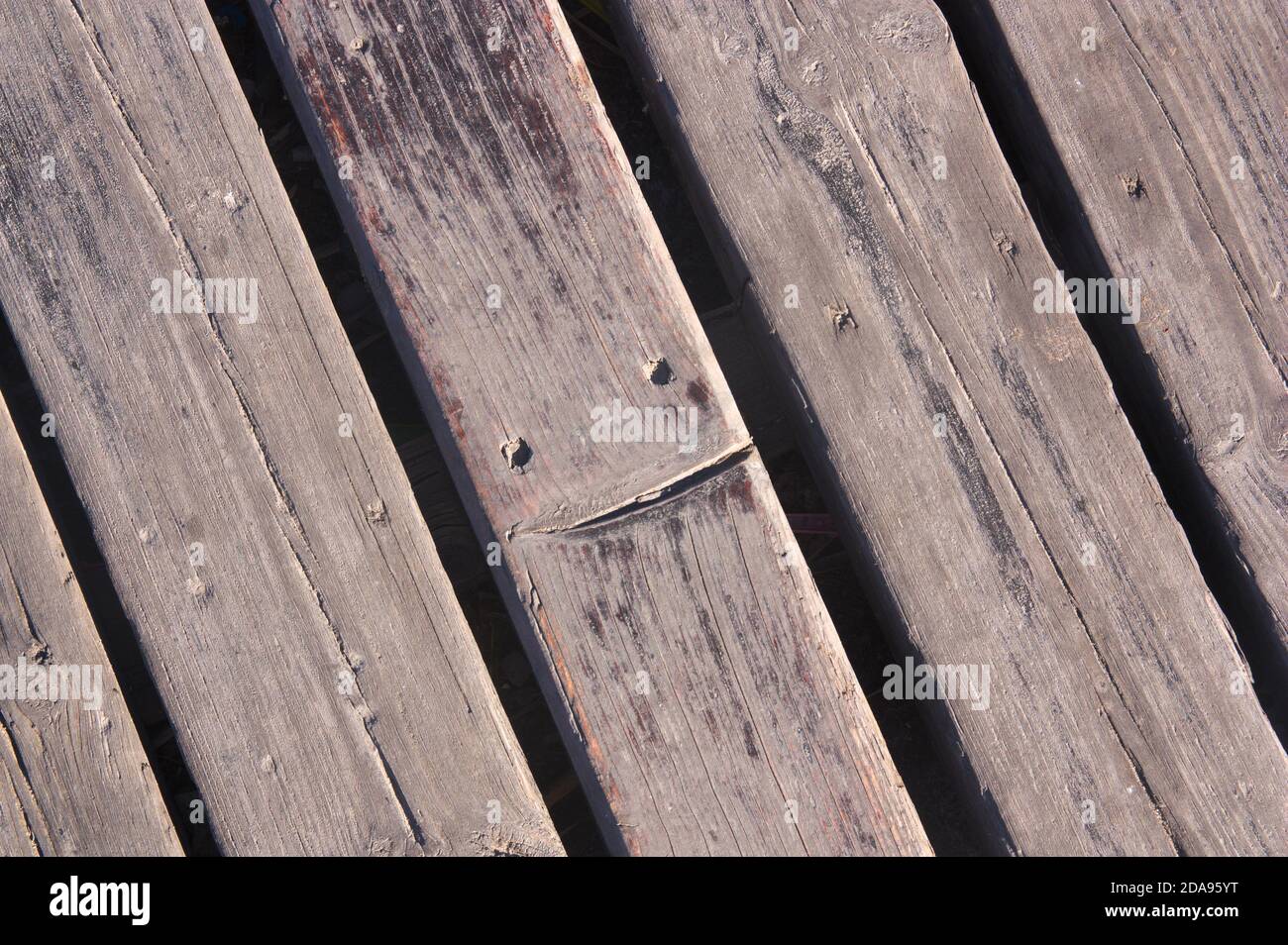 Close-up of a wooden floor on which one of the planks has a smile engraved on it Stock Photo
