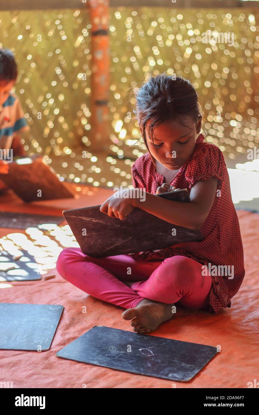 COX'S BAZAR, BANGLADESH - NOVEMBER 25, 2017: A girl Rohingya Muslims refugee child at the camp learning center. Stock Photo