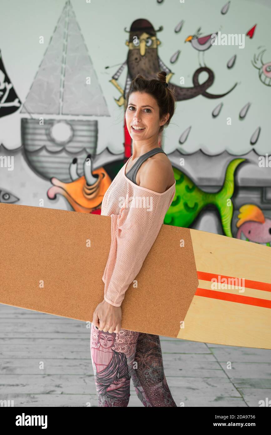 Woman holding indoor SUP board Stock Photo