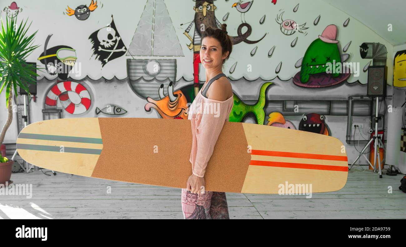 Woman holding surf board hi-res stock photography and images - Alamy