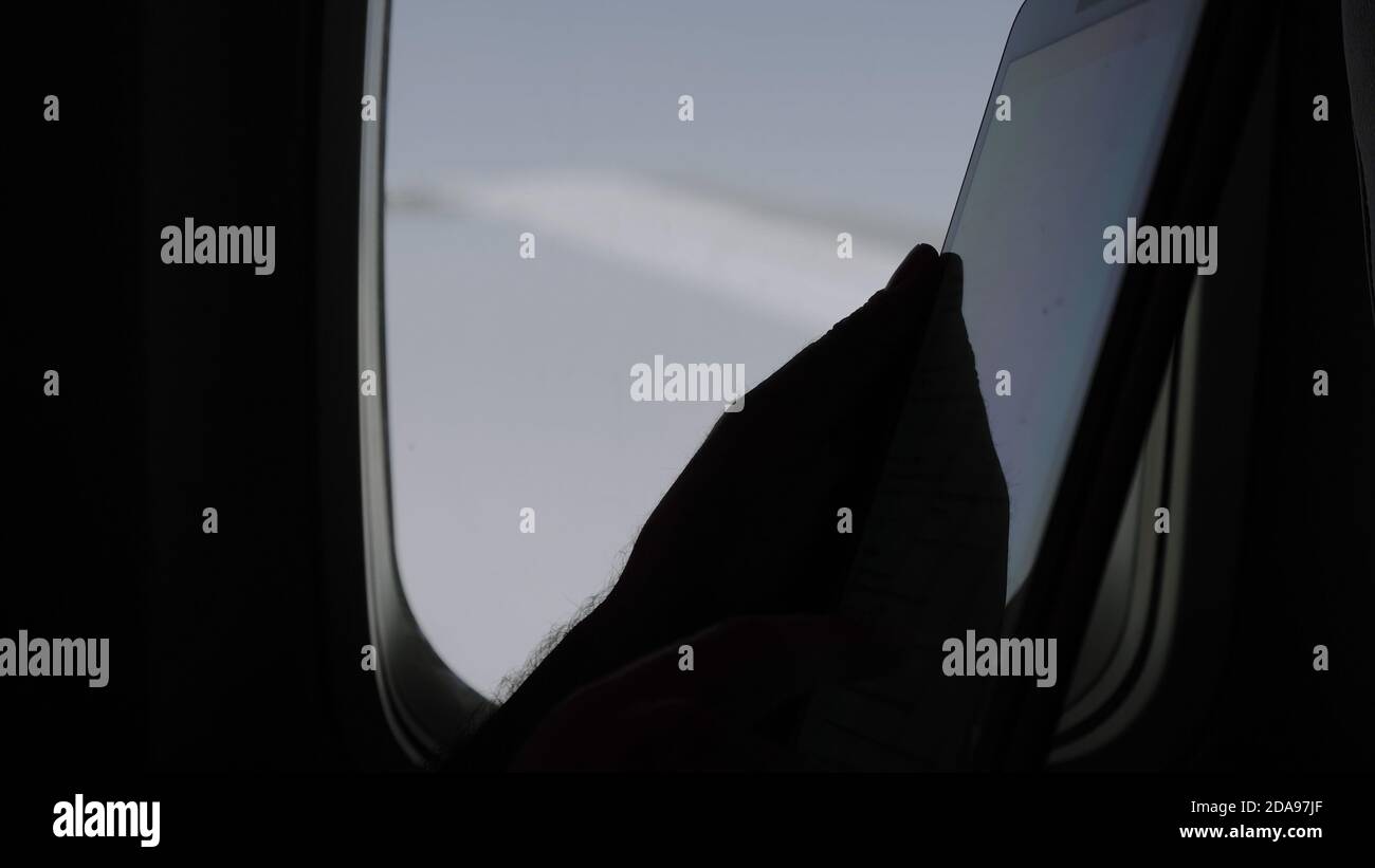 Using tablet computer on a flight. Stock Photo