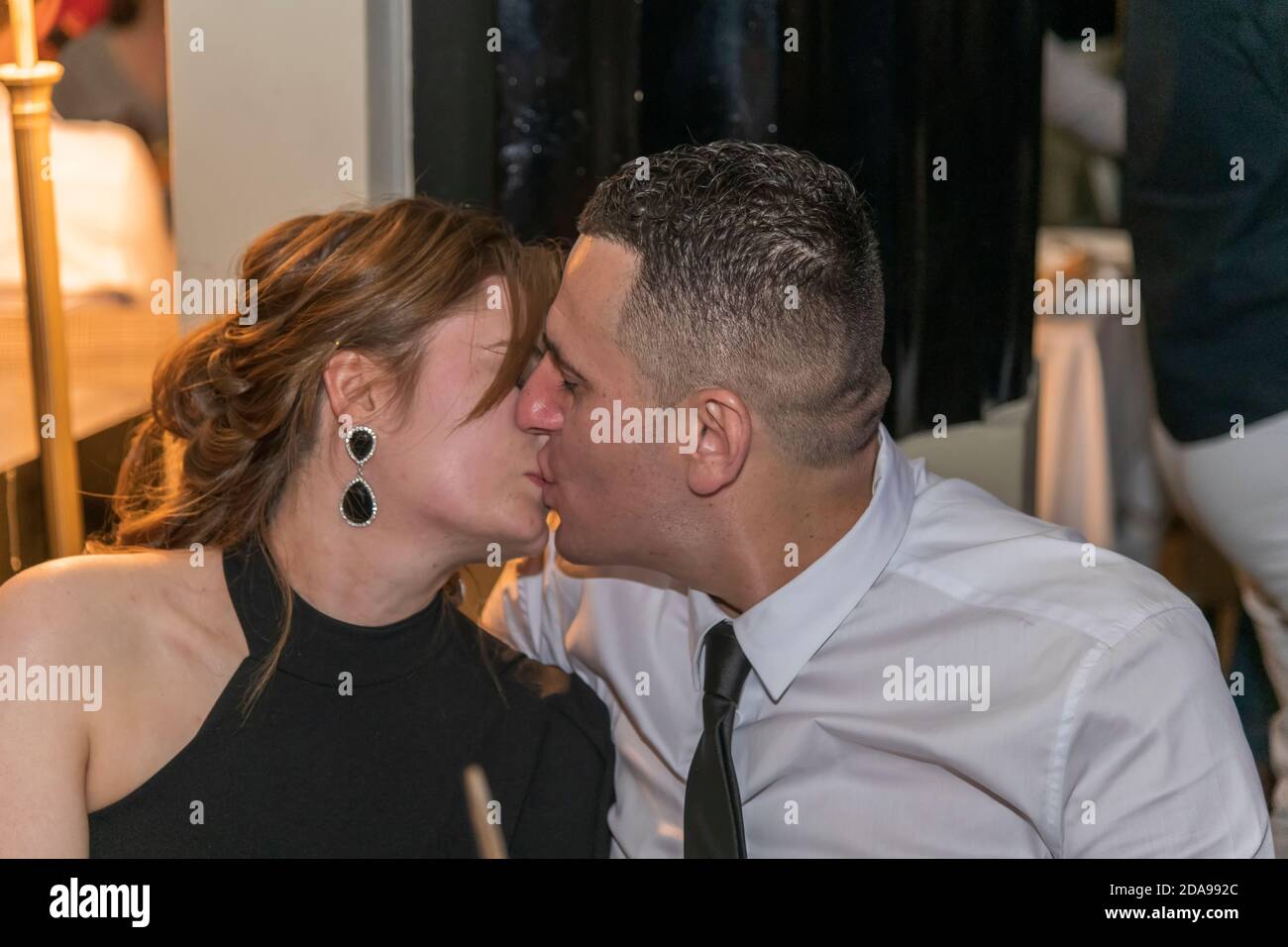 Beautiful couple hugging and kissing in the restaurant, London, UK Stock Photo